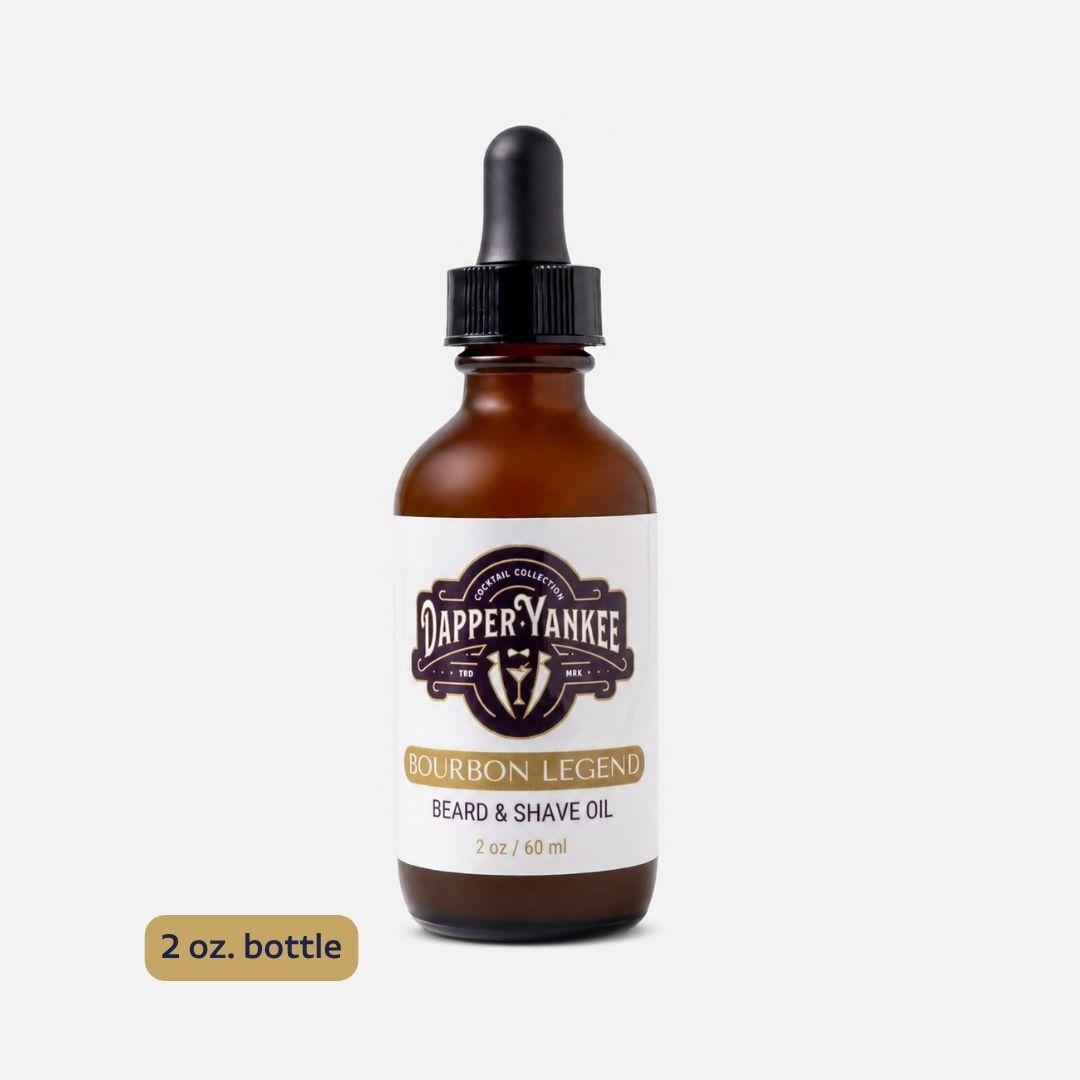A 2 oz amber glass dropper bottle of Dapper Yankee Bourbon Legend Beard & Shave Oil, shown on a light gray background with a '2 oz. bottle' label overlay.