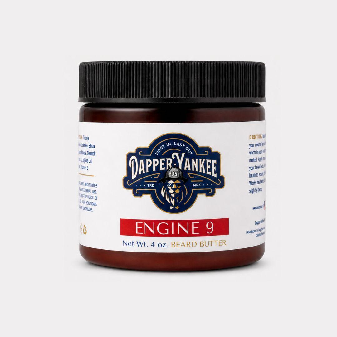 A 4 oz jar of Dapper Yankee Engine 9 Beard Butter with a black ribbed lid and a white label featuring the brand logo and product name, set against a light gray background.