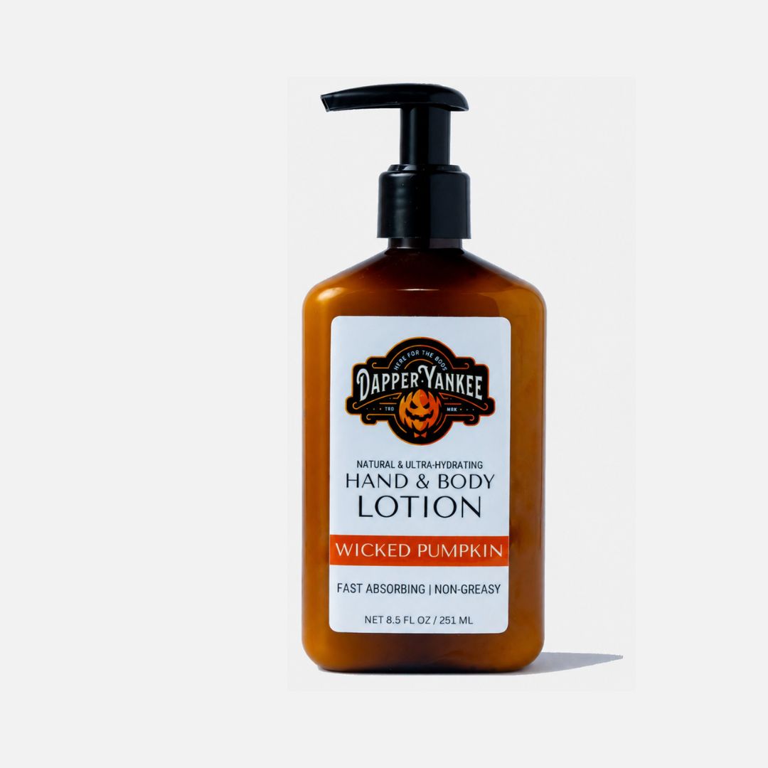 Dapper Yankee Wicked Pumpkin Hand & Body Lotion in an amber bottle with a black pump dispenser and a white label, set against a light gray background.