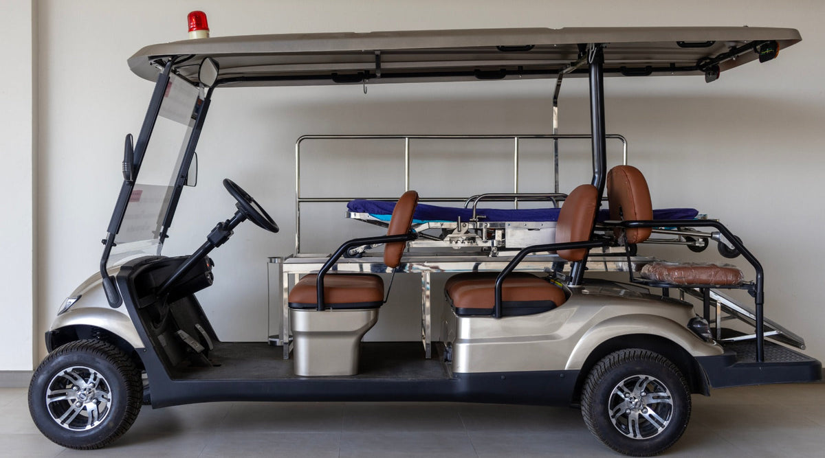 A large golf cart with six seats built into it. The golf cart is parked inside of a spacious garage.