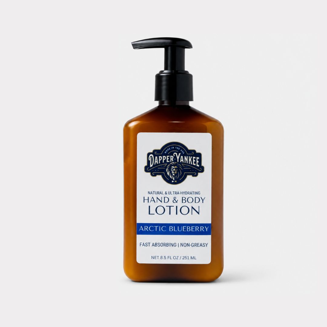 A bottle of Dapper Yankee Arctic Blueberry Hand & Body Lotion in an amber brown bottle with a black pump dispenser and a white label, set against a light gray background.