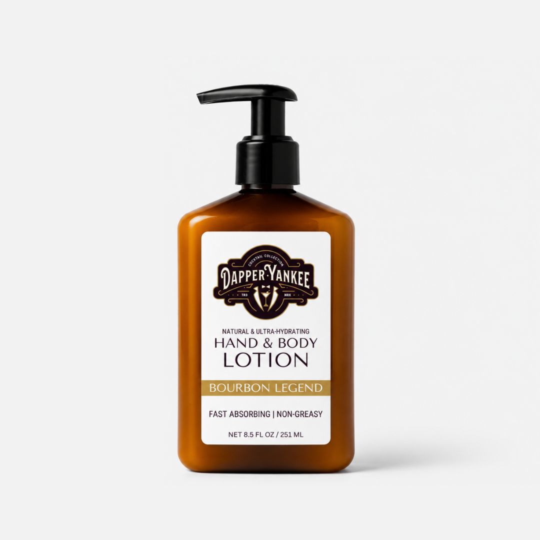 A bottle of Dapper Yankee Bourbon Legend Hand & Body Lotion in an amber brown bottle with a black pump dispenser and a white label, set against a light gray background.