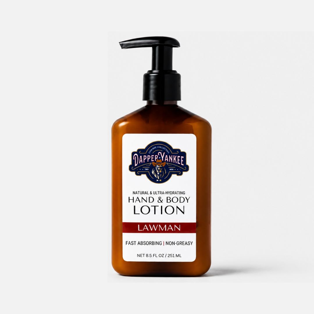 Dapper Yankee Lawman hand and body lotion in an amber brown pump bottle with a black dispenser and a white label, set against a light gray background.