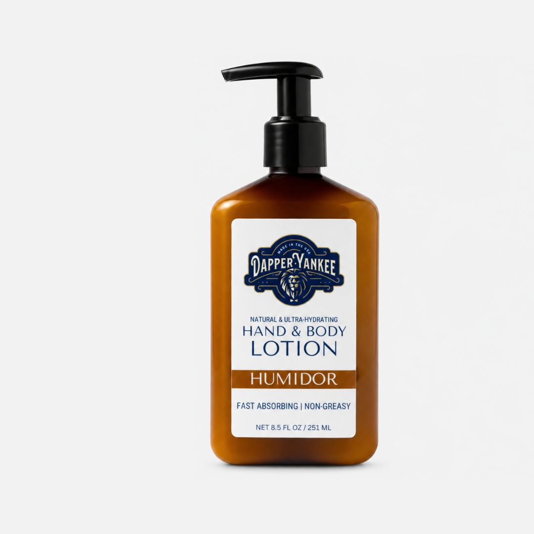 A bottle of Dapper Yankee Hand & Body Lotion in the Humidor scent, featuring an amber-colored bottle with a black pump and a white label.