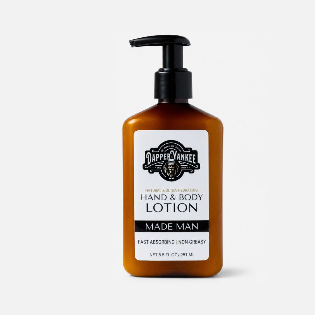 A 8.5 fl oz amber bottle of Dapper Yankee Made Man Hand & Body Lotion with a black pump dispenser and a white label, set against a light gray background.