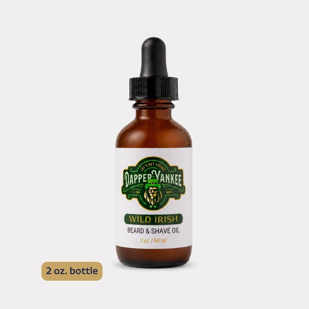 A 2 oz amber glass dropper bottle of Dapper Yankee Wild Irish Beard & Shave Oil, shown on a light gray background with a small '2 oz. bottle' label overlay in the bottom left corner.